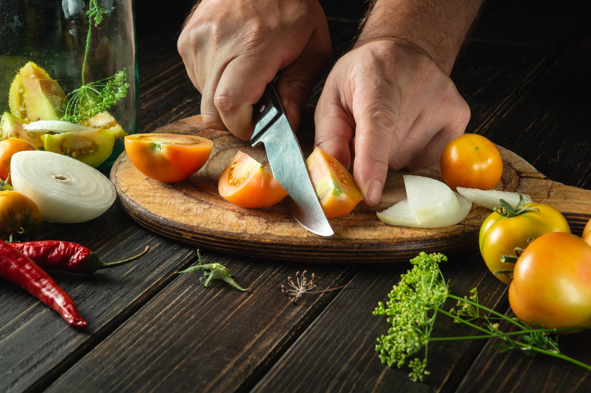 Chef slicing seasonal vegetables
